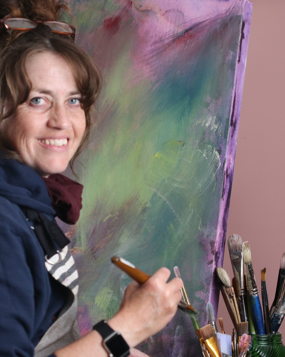 Taryn Giles in her studio Taryn Giles at her easel in the studio, brush in hand